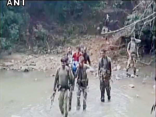CRPF personnel carry woman suffering from high fever on stretcher for 7 km CRPF personnel carry woman suffering from high fever on stretcher for 7 km