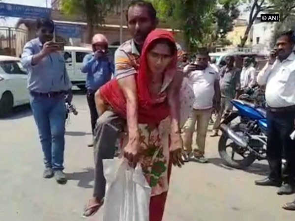 Mathura: Woman carries differently-abled husband on shoulders Mathura: Woman carries differently-abled husband on shoulders