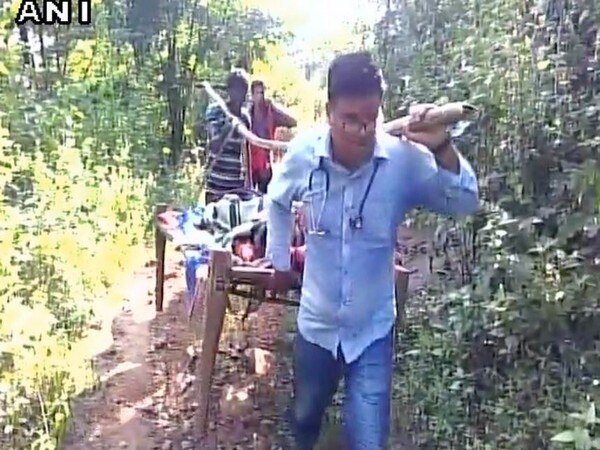 Doctor carries woman on cot for 8 km in Odisha Doctor carries woman on cot for 8 km in Odisha