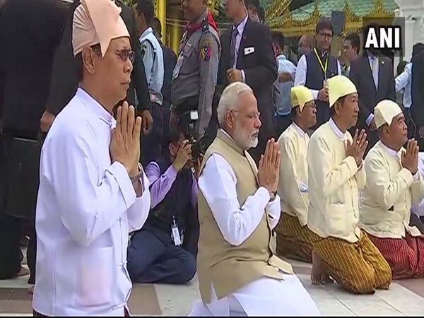 PM Modi signs guest book at Shwedagon Pagoda in Yangon PM Modi signs guest book at Shwedagon Pagoda in Yangon