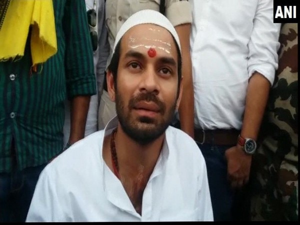 Bihar: Armed man clutches Tej Pratap's hand Bihar: Armed man clutches Tej Pratap's hand