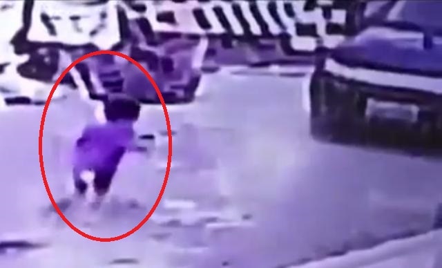 Incredible video: Toddler cheats death after being run over by his unaware mother Incredible video: Toddler cheats death after being run over by his unaware mother