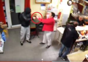 Woman of steel: Watch lady holding baby fights off gun wielding robber
