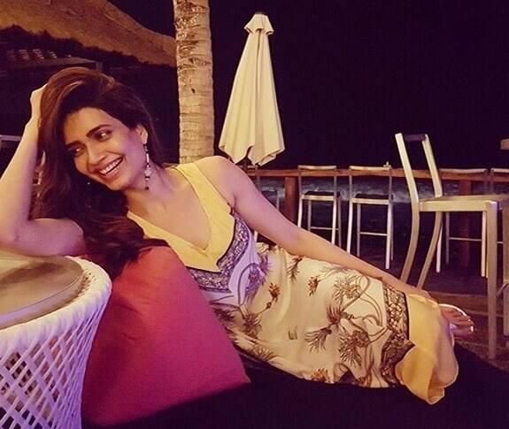 Karishma looks relaxed and happy as she poses in a comfortable dress in the evening. 