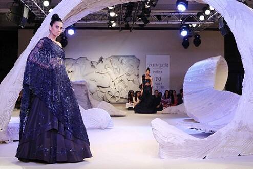 A model walks the ramp displaying an outfit by fashion designer Gaurav Gupta 