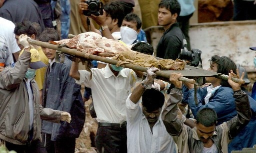 Rescue workers carry a body which was recovered from beneath a landslide in the Saki Naka suburb of Mumbai.