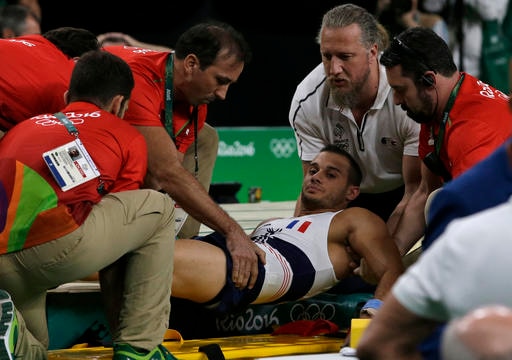 France's Samir Ait Said is assisted after injuring his leg in the vault during the artistic gymnastics men's qualification at the 2016 Summer Olympics in Rio de Janeiro, Brazil, Saturday, Aug. 6, 2016. (AP Photo/Rebecca Blackwell)