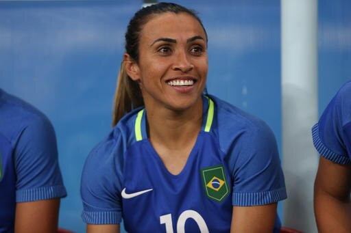 Brazil's Marta smiles sitting on the bench during a group E match of the women's Olympic football tournament between South Africa and Brazil at the Arena Amazonia stadium in Manaus, Brazil, Tuesday, Aug. 9, 2016. (AP Photo/Michael Dantas)