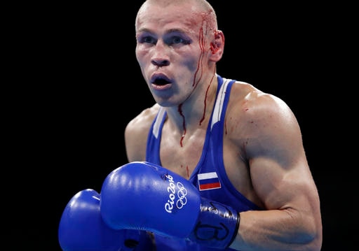 Russia's Nikitin Vladimir bleeds from cuts in his head as he fights Vanuatu's Boe Warawara during a men's bantamweight 56-kg preliminary boxing match at the 2016 Summer Olympics in Rio de Janeiro, Brazil, Wednesday, Aug. 10, 2016. (AP Photo/Frank Franklin II)