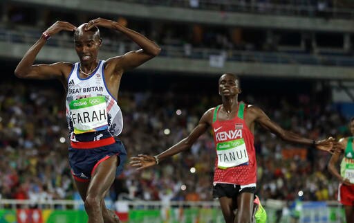 Britain's Mo Farah, left, and Kenya's silver medal winner Paul Kipngetich Tanui compete in the men's 10,000-meter final during the athletics competitions in the Olympic stadium of the 2016 Summer Olympics in Rio de Janeiro, Brazil. (AP)