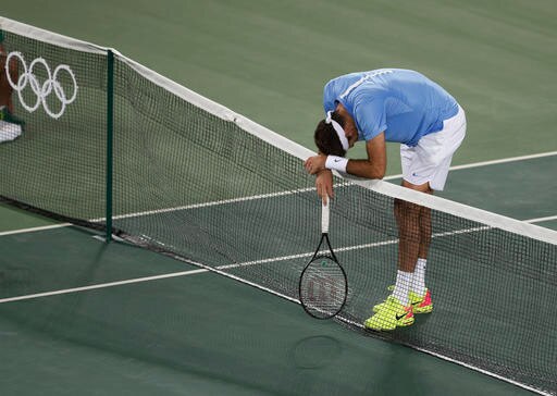 Argentina's Juan Martin del Potro leans on the net after losing a point to Great Britain's Andy Murray in the gold medal match of the men's singles tennis competition at the 2016 Summer Olympics in Rio de Janeiro, Brazil, Sunday, Aug. 14, 2016. (AP Photo/Vadim Ghirda)