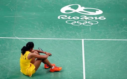 India's V. Sindhu Pusarla sits on the court after losing to Spain's Carolina Marin in the women's badminton singles gold medal match at the 2016 Summer Olympics in Rio de Janeiro, Brazil, Friday, Aug. 19, 2016. (AP Photo/Vincent Thian)