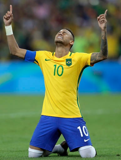 Brazil's Neymar weeps as he kneels down to celebrate after scoring the decisive penalty kick during the final match of the men's Olympic football tournament between Brazil and Germany at the Maracana stadium in Rio de Janeiro, Brazil, Saturday Aug. 20, 2016. Brazil won the gold medal on a penalty shootout. (AP Photo/Andre Penner)