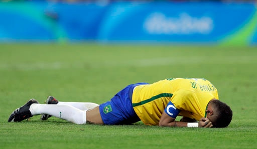Brazil's Neymar cries as he lies on the pitch to celebrate after scoring the decisive penalty kick during the final match of the men's Olympic football tournament between Brazil and Germany at the Maracana stadium in Rio de Janeiro, Brazil, Saturday Aug. 20, 2016. Brazil won the gold medal on a penalty shootout.(AP Photo/Andre Penner)