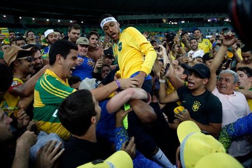Brazil's Neymar celebrates with the crowd after the gold medal ceremony of the men's Olympic football tournament between Brazil and Germany at the Maracana stadium in Rio de Janeiro, Brazil, Saturday Aug. 20, 2016. Brazil won the gold medal on penalty shoot-out.(AP Photo/Andre Penner)