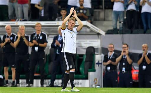 Germany's captain Bastian Schweinsteiger claps hands to the German fans for the last time while he leaves the pitch during a friendly soccer match between Germany and Finland in Moenchengladbach, Germany, Wednesday, Aug. 31, 2016. Schweinsteiger made his last match for the national team. (AP Photo/Martin Meissner)