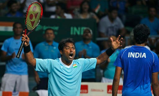 India's Leander Paes, left, celebrates a point with teammate Saketh Myneni during the Davis Cup world group play-off against Spain's Rafael Nadal and Marc Lopez in New Delhi, India, Saturday, Sept. 17, 2016. (AP Photo/Tsering Topgyal)