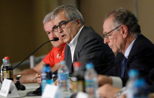 The head of communications of the Rio 2016 Mario Andrada, center, speaks aside the Rio 2016 Organizing Committee president, Carlos Arthur Nuzman, right, during a press conference about Iran's cyclist Bahman Golbarnezhad who died after crashing in a road race during the Paralympic Games in Rio de Janeiro, Brazil, Saturday, Sept. 17, 2016. (AP Photo/Leo Correa)