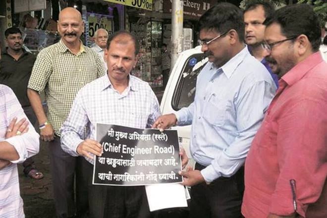 'I...am responsible for potholes in the city', BMC official forced to hold this embarrassing placard by MNS 'I...am responsible for potholes in the city', BMC official forced to hold this embarrassing placard by MNS