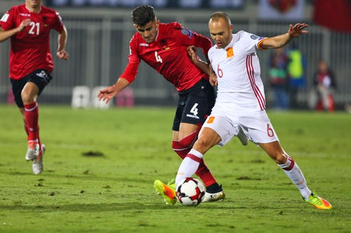 Albania's Elseid Hysaj fight for the ball with Spain's Andres Iniesta, right, during their World Cup Group G qualifying soccer match at Loro Borici Stadium, in Shkoder, northern Albania. (AP)