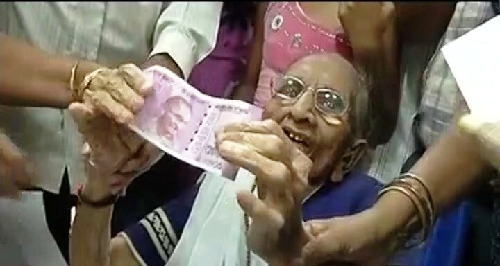 PM Narendra Modi's mother Heeraba visits bank in Gandhinagar to exchange old currency notes PM Narendra Modi's mother Heeraba visits bank in Gandhinagar to exchange old currency notes