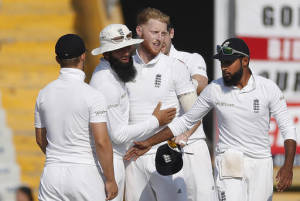 England's cricketers celebrate the dismissal of India's Umesh Yadav on the third day of their third cricket test match in Mohali, India, Monday, Nov. 28, 2016. (AP Photo/Altaf Qadri)