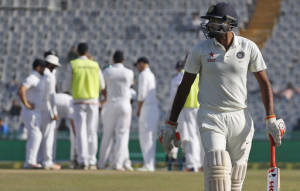 India's Ravichandran Ashwin walks back to the pavilion after being dismissed on the third day of their third cricket test match against England in Mohali, India, Monday, Nov. 28, 2016. (AP Photo/Altaf Qadri)