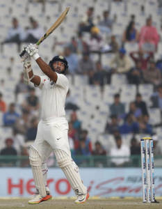 India's Parthiv Patel hits a boundary on the fourth day of the third cricket test match against England, in Mohali, India, Tuesday, Nov. 29, 2016. (AP Photo/Altaf Qadri)