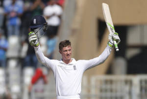 England's batsman Keaton Jennings raises his bat and helmet after scoring century on the first day of the fourth cricket test match between India and England in Mumbai, India, Thursday, Dec. 8, 2016. (AP Photo/Rafiq Maqbool)