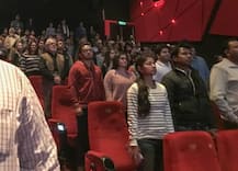 Six in custody for not standing for national anthem