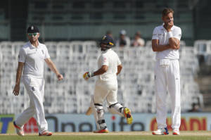 England's Liam Dawson, left, and Stuart Broad, right, react after India's Karun Nair, center, hit a boundary during their fourth day of the fifth cricket test match in Chennai (AP PHOTO)