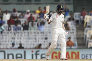 India's Lokesh Rahul raises his bat after scoring half century against England during their third day of the fifth cricket test match in Chennai (AP Photo)