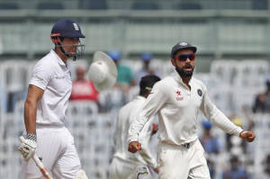 India's captain Virat Kohli, right, celebrates the dismissal of England's captain Alastair Cook, left, during their fifth day of the fifth cricket test match in Chennai. (AP PHOTO)