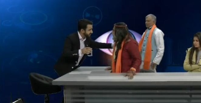 SHOCKING: Swami Om splashes water on news anchor during a show SHOCKING: Swami Om splashes water on news anchor during a show