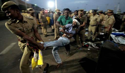 Protester fighting police official in protest in favour of Jallikattu. (AP Photo)