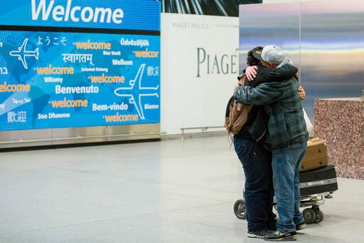 Travellers arrive in US to hugs and tears after ban is lifted Travellers arrive in US to hugs and tears after ban is lifted