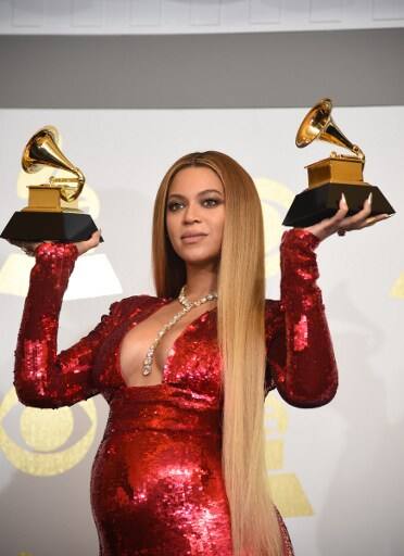 Pop superstar Beyonce who is expecting twins poses with her Grammy trophies (Picture credit: AFPForum)