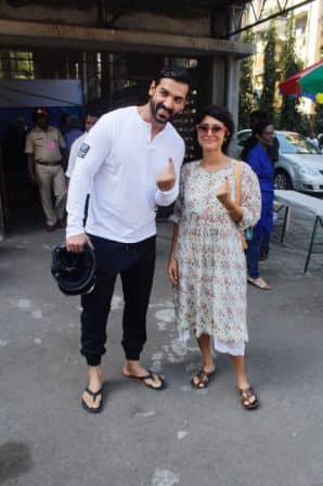 Director-producer Kiran Rao and actor John Abraham pose for the cameras after casting their vote. (Picture credit: Manav Manglani)