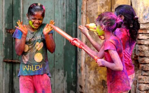 Indian revellers play with colours during Holi celebrations in Chennai on March 13, 2017. The Hindu festival of Holi, or the 'Festival of Colours' heralds the arrival of spring and the end of winter. / AFP PHOTO / ARUN SANKAR