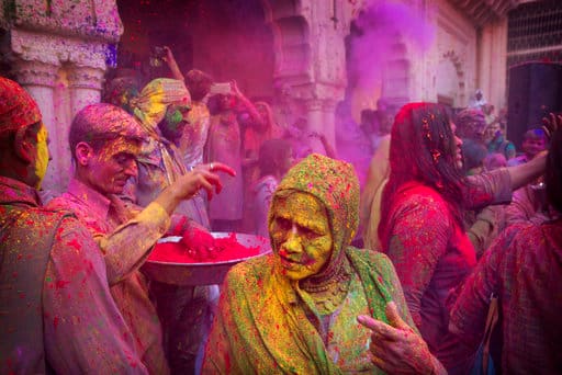 In this Thursday, March 9, 2017, photo, an Indian widow smeared with colors play Holi at the Gopinath temple, in Vrindavan, 180 kilometers (112 miles) south-east of New Delhi, India. Up to just a few years ago the festival was forbidden for Hindu widows. Like hundreds of thousands of observant Hindu women, they would have been expected to live out their days in quiet worship, dressed only in white, with their very presence being considered inauspicious for all religious festivities. (AP Photo /Manish Swarup, File)