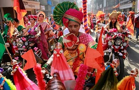 Women from western Maharashtra state dressed in traditional attire ride on motorcycles during a procession to celebrate