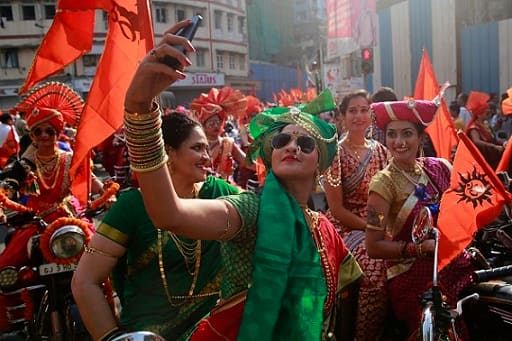 Gudhi Padva is derived from the Sanskrit name for Chaitra Shukla Pratipad. It is celebrated on the first day of the Chaitra month to mark the beginning of the New year according to the lunisolar Hindu calendar. (Women from western Maharashtra state dressed in traditional attire take selfies as they ride on motorcycles during a procession to celebrate