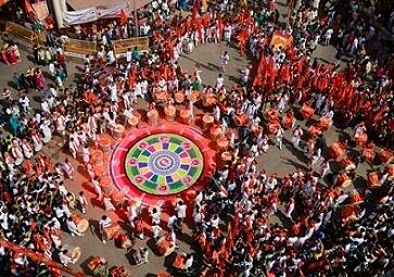 People of western Maharashtra state dressed in traditional attire perform during a procession to celebrate