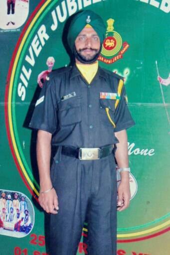 This picture taken on May 1, 2017 in Vein Pein village, some 45 km from Amritsar, shows a photograph within the Singh family's residence of slain Indian army soldier Paramjeet Singh/ AFP PHOTO