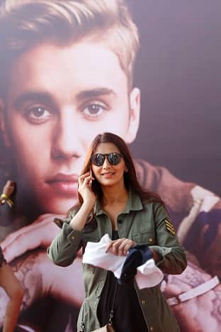 Bollywood actor Sonali Bendre takes a call while standing infront of a poster of Justin Bieber(Sherwin Crasto/SOLARIS IMAGES)