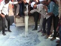 Maharashtra farmers protest by spilling milk, dumping vegetables on road