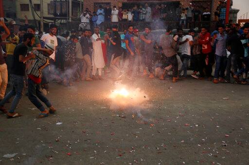 Kashmiris light fire crackers as they celebrate India losing two early wickets during the Champions Trophy cricket final match between India and Pakistan, in Srinagar, Indian controlled Kashmir, Sunday, June 18, 2017. (AP Photo/Mukhtar Khan)