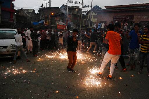 Kashmiris light fire crackers as they celebrate India losing two early wickets during the Champions Trophy cricket final match between India and Pakistan, in Srinagar, Indian controlled Kashmir, Sunday, June 18, 2017. (AP Photo/Mukhtar Khan)