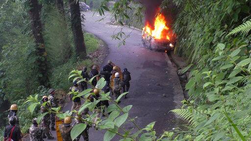 Sikkim government sources in Gangtok said they had yesterday requested their West Bengal counterpart to provide security to vehicles passing through Darjeeling district in NH 31A in view of the GJM agitation. --Caption: Security personnel watch from a distance as a vehicle torched by suspected protestors goes up in flames in Darjeeling, India, Thursday, June 15, 2017. (AP Photo)