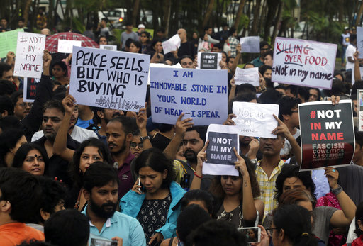 Protestors hold placards in Mumbai. PIC/AP.